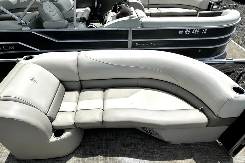 Slide: The Image of 2022 Cypress Cay Seabreeze 232 pontoon boat with comfortable seating and cup holders. - 10