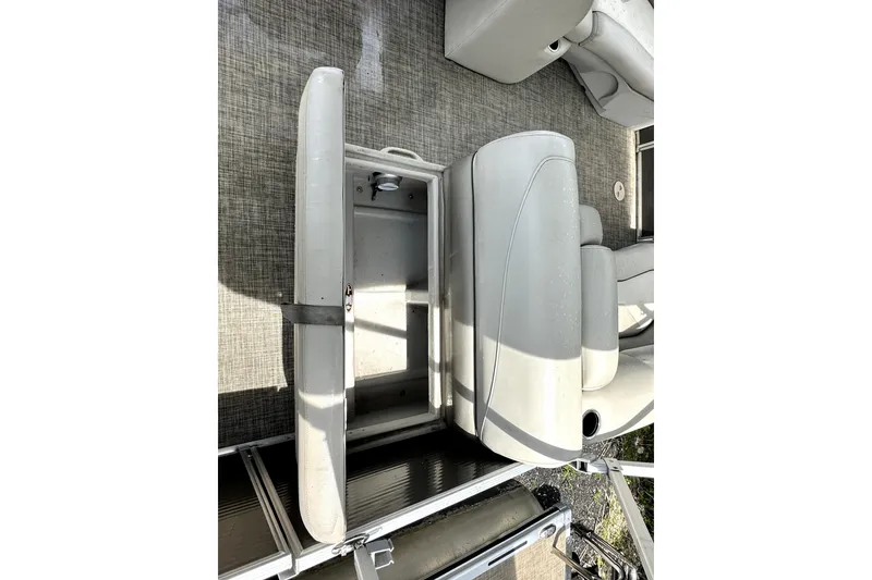 Slide: The Image of 2022 Cypress Cay Seabreeze 232 boat seat with storage compartment open. - 17