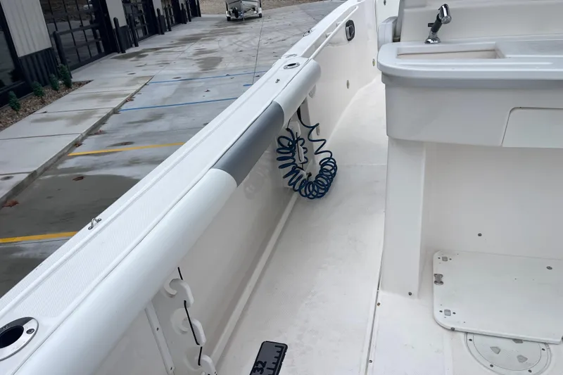 Slide: The Image of 2012 Everglades 295 Center Console boat interior with coiled hose and sink. - 15