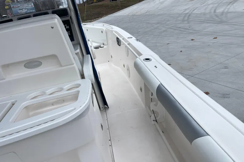 Slide: The Image of 2012 Everglades 295 Center Console boat interior with white seating and storage compartments. - 16