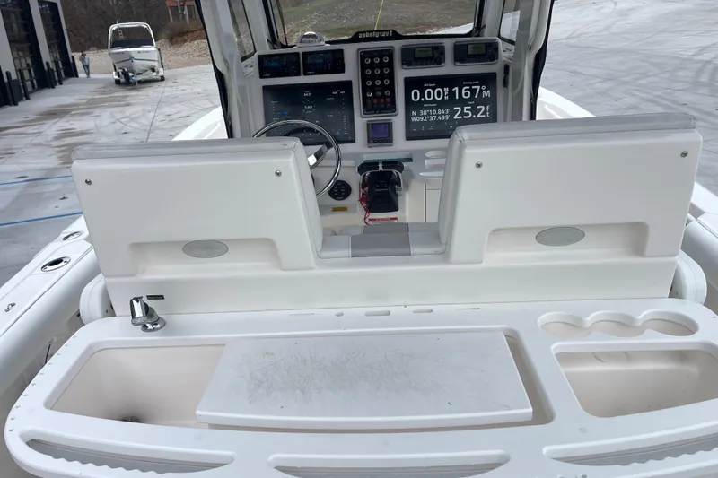 Slide: The Image of 2012 Everglades 295 Center Console boat dashboard with navigation and control systems. - 17