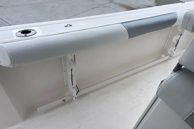 Slide: The Image of 2012 Everglades 295 Center Console boat interior with rod holders and cushioned seating. - 20