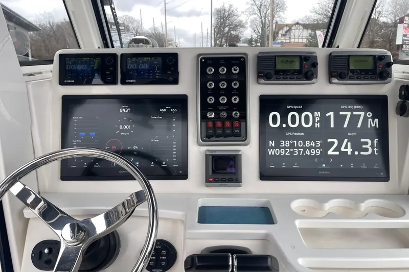 Slide: The Image of Dashboard of 2012 Everglades 295 Center Console with Garmin navigation displays and controls. - 21