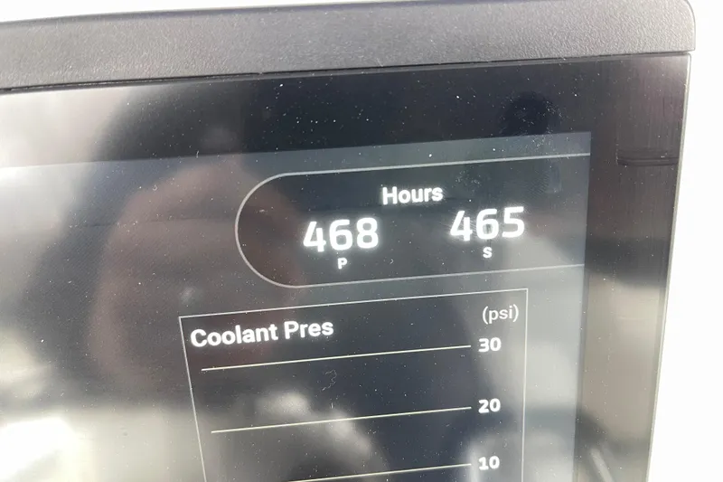 Slide: The Image of Display screen showing engine hours and coolant pressure on a 2012 Everglades 295 Center Console. - 22