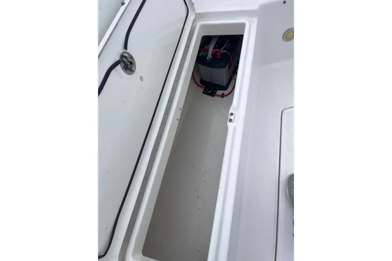 Slide: The Image of Open storage compartment on 2012 Everglades 295 Center Console boat, showing battery inside. - 30
