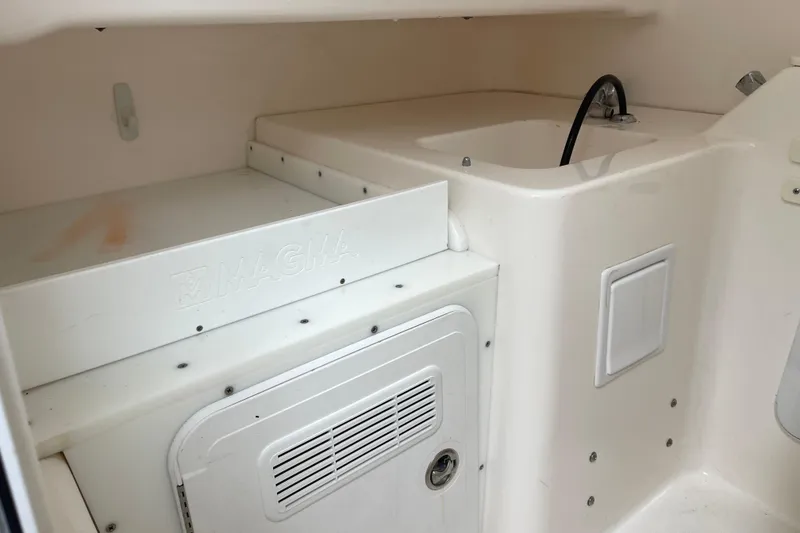 Slide: The Image of Interior of 2012 Everglades 295 Center Console boat with sink and storage area. - 34