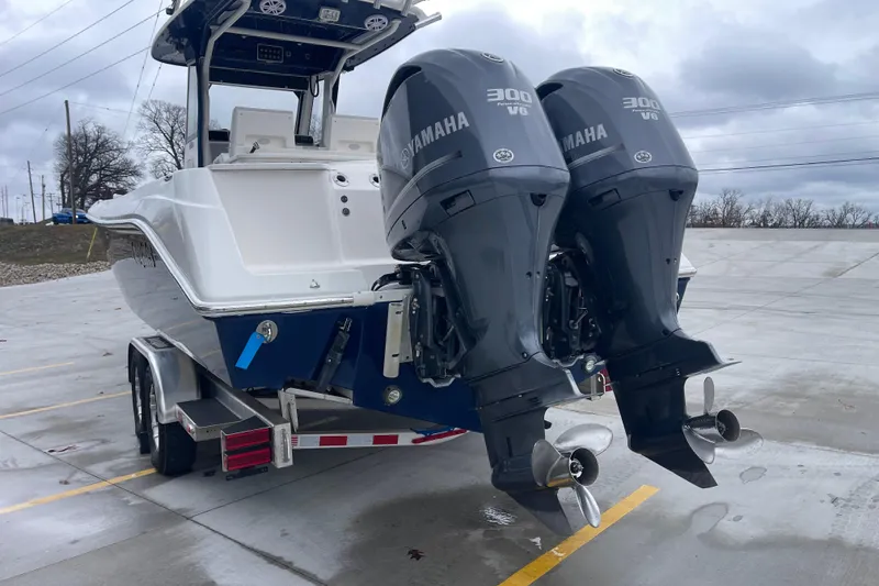 Slide: The Image of 2012 Everglades 295 Center Console with twin Yamaha 300 V6 engines on a trailer. - 5