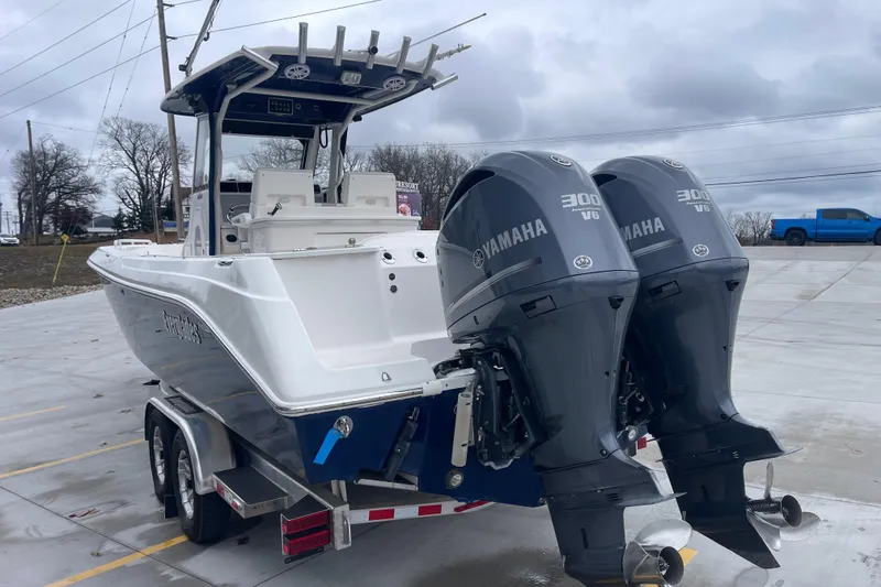 Slide: The Image of 2012 Everglades 295 Center Console boat with twin Yamaha 300 engines on a trailer. - 6