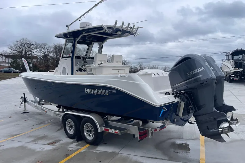 Slide: The Image of 2012 Everglades 295 Center Console boat on trailer with Yamaha engines, parked outdoors. - 7