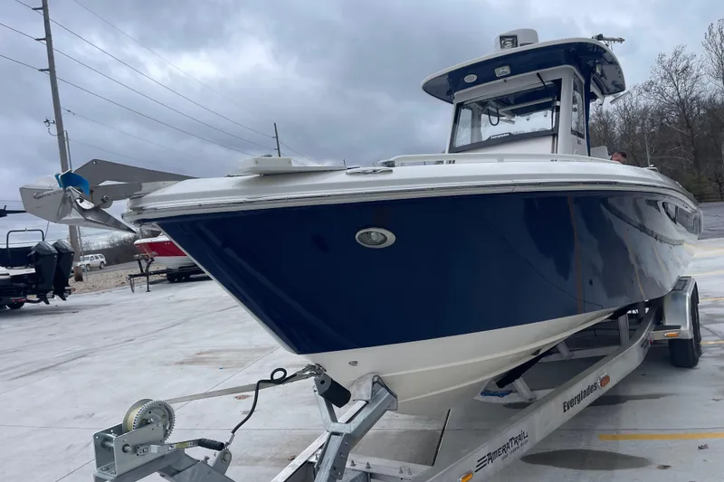 Slide: The Image of 2012 Everglades 295 Center Console boat on trailer, overcast sky background. - 9