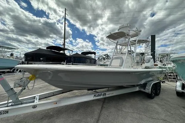 The Image of 2024 Avenger AV26 boat on trailer under cloudy sky at marina. - 1