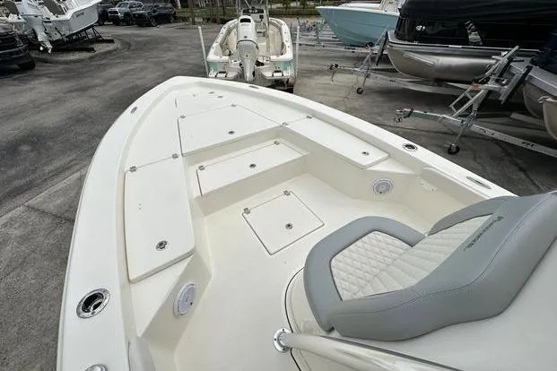 Slide: The Image of 2024 Avenger AV26 boat with spacious deck and seating, displayed in a showroom. - 6