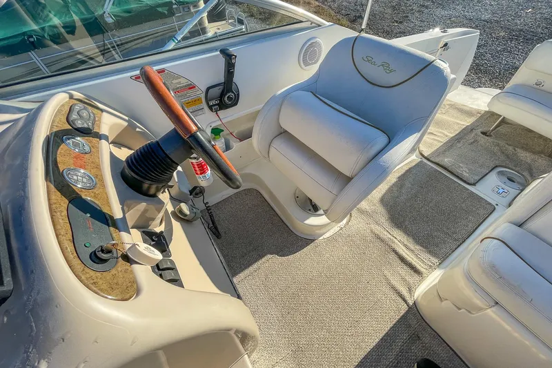 Slide: The Image of Interior of 2000 Sea Ray 260 Sundancer boat with steering wheel and seating. - 12