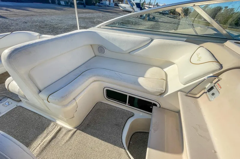 Slide: The Image of Interior seating of 2000 Sea Ray 260 Sundancer boat, featuring white upholstery. - 13