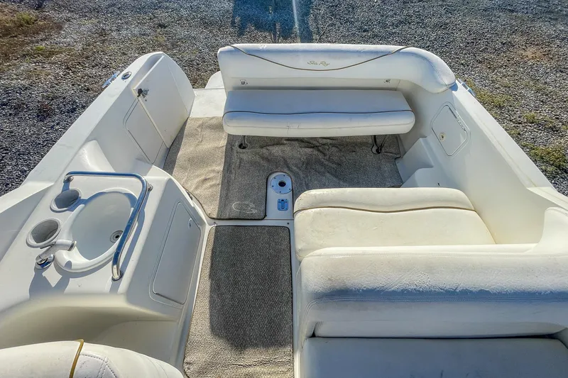 Slide: The Image of 2000 Sea Ray 260 Sundancer boat interior with white seating and sink. - 14