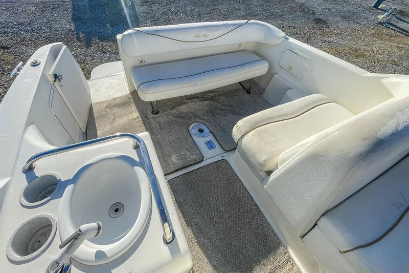 Slide: The Image of 2000 Sea Ray 260 Sundancer boat interior with seating and sink. - 15