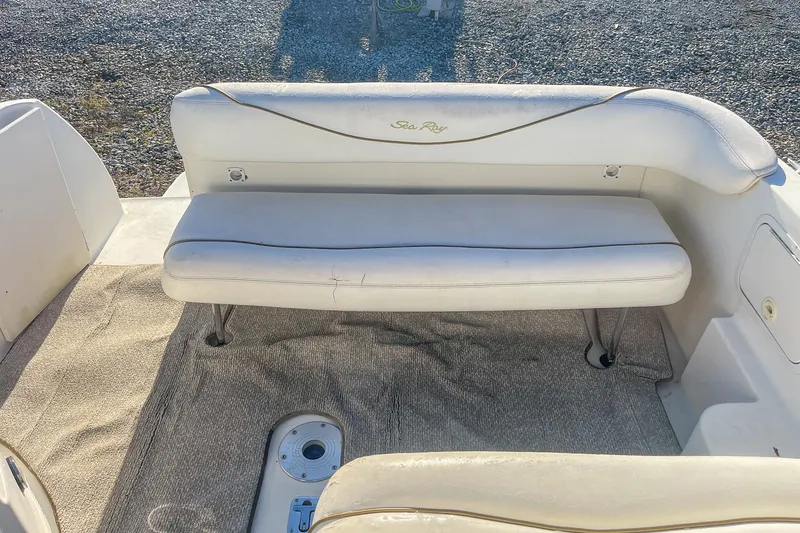 Slide: The Image of 2000 Sea Ray 260 Sundancer boat interior with white seating and carpeted floor. - 16