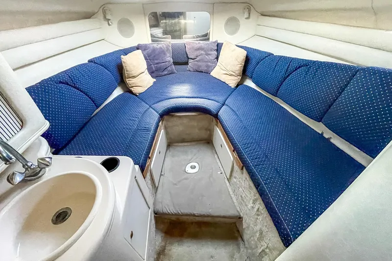 Slide: The Image of Interior of 2000 Sea Ray 260 Sundancer with blue seating and compact sink. - 19