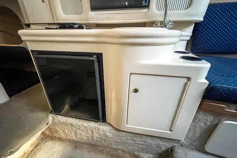 Slide: The Image of Interior of 2000 Sea Ray 260 Sundancer with kitchenette and seating area. - 24