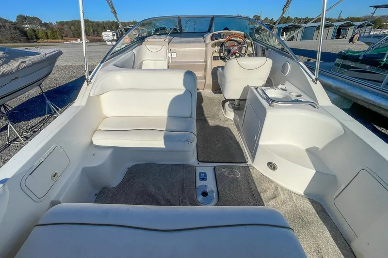 Slide: The Image of 2000 Sea Ray 260 Sundancer boat interior with seating and steering wheel. - 7