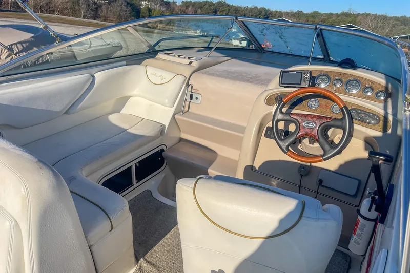 Slide: The Image of Interior of a 2000 Sea Ray 260 Sundancer boat with steering wheel and dashboard. - 9