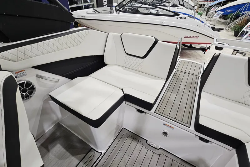 Slide: The Image of 2024 Yamaha Boats 222SE interior with white seating and sleek design. - 11