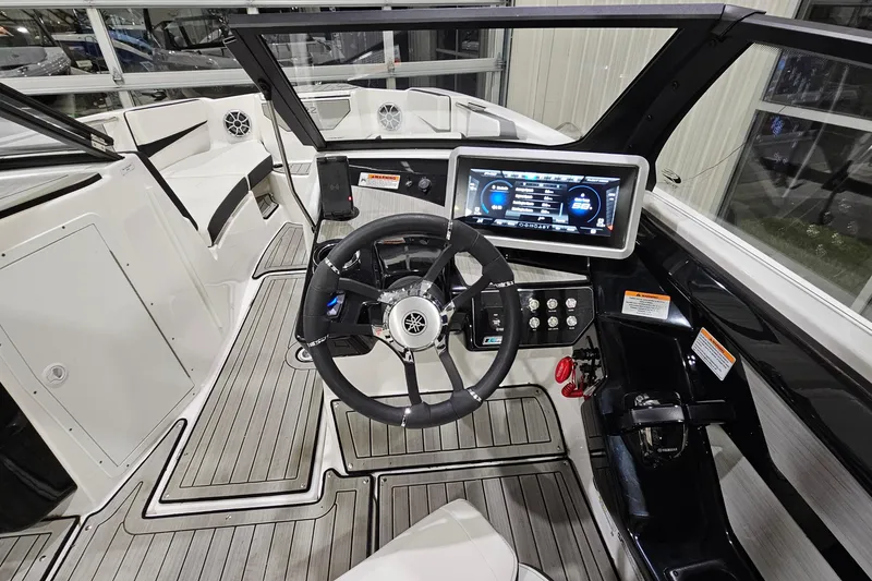 Slide: The Image of 2024 Yamaha Boats 222SE cockpit with modern steering and digital display. - 14