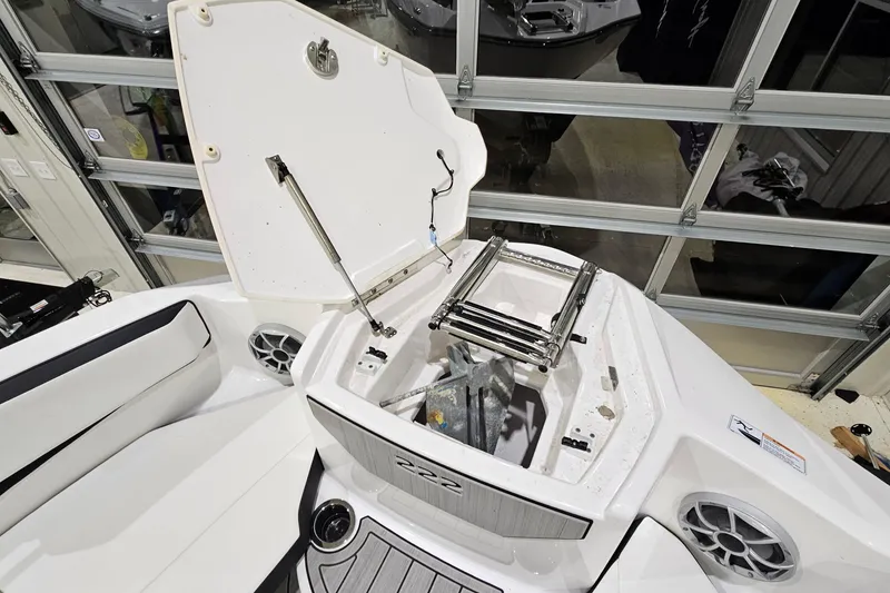 Slide: The Image of 2024 Yamaha Boats 222SE with open storage compartment and ladder, showcasing interior features. - 20