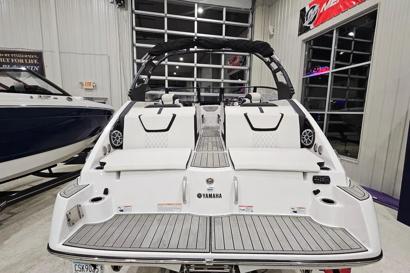 Slide: The Image of 2024 Yamaha Boats 222SE, sleek white design, luxury seating, modern features, indoor showroom display. - 5