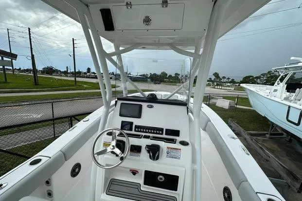 Slide: The Image of 2024 Sea Fox 248 Commander boat dashboard with steering wheel and controls. - 3