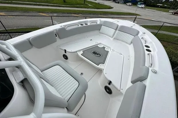 Slide: The Image of 2024 Sea Fox 248 Commander boat interior with cushioned seating and storage compartments. - 4
