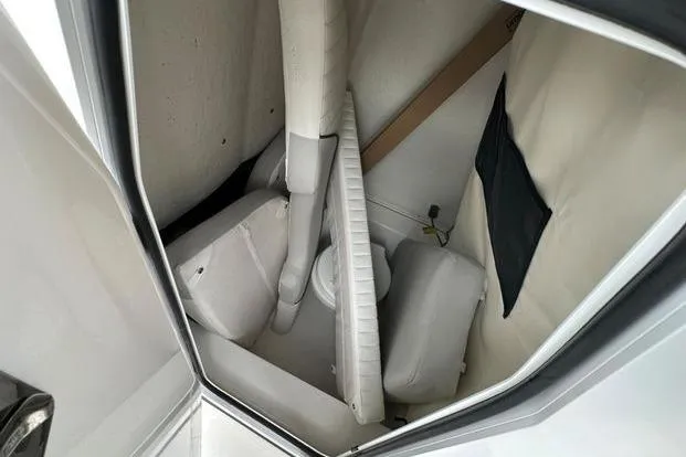 Slide: The Image of 2024 Sea Fox 248 Commander interior storage compartment with cushions and equipment. - 6