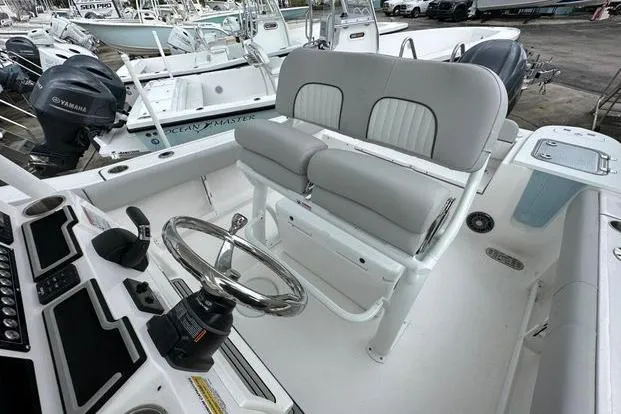 Slide: The Image of 2024 Sea Fox 248 Commander boat interior with steering wheel and seating. - 7