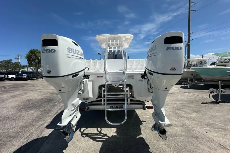 Slide: The Image of 2025 Twin Vee 260 GFX2 CC boat with dual Suzuki 200 engines, rear view. - 3