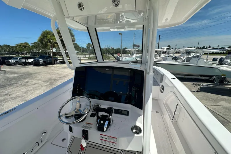 Slide: The Image of 2025 Twin Vee 260 GFX2 CC boat console with steering wheel and controls. - 4