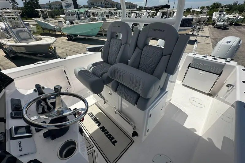 Slide: The Image of 2025 Twin Vee 260 GFX2 CC boat interior with dual seats and steering wheel. - 8