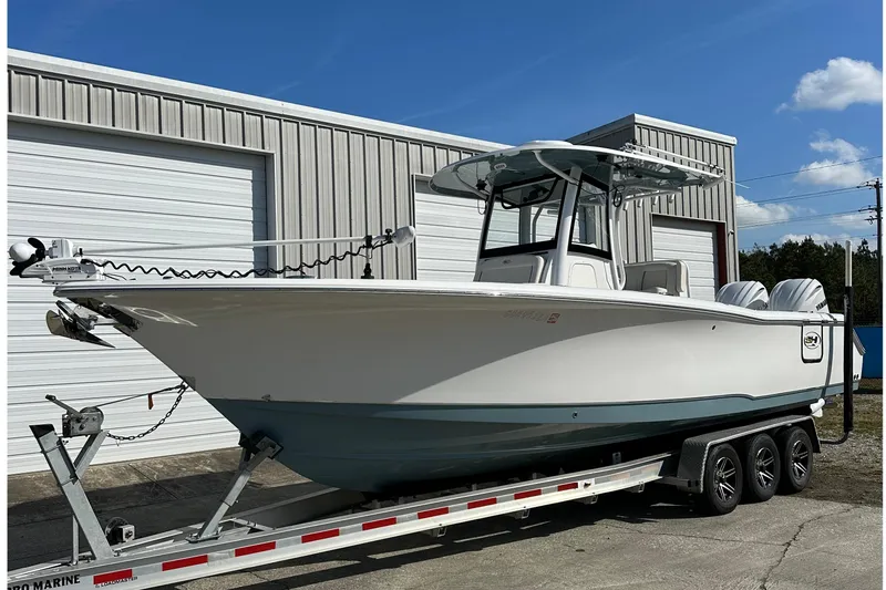 The Image of 2022 Sea Hunt Gamefish 30 Coffin Box boat on trailer, parked outside a warehouse. - 1