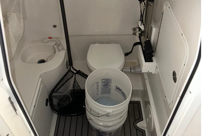 Slide: The Image of 2022 Sea Hunt Gamefish 30 Coffin Box interior with toilet, sink, and fishing gear. - 13