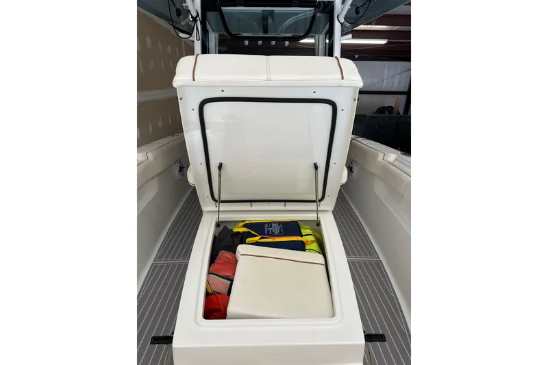 Slide: The Image of 2022 Sea Hunt Gamefish 30 Coffin Box with open storage compartment, showcasing life jackets. - 18