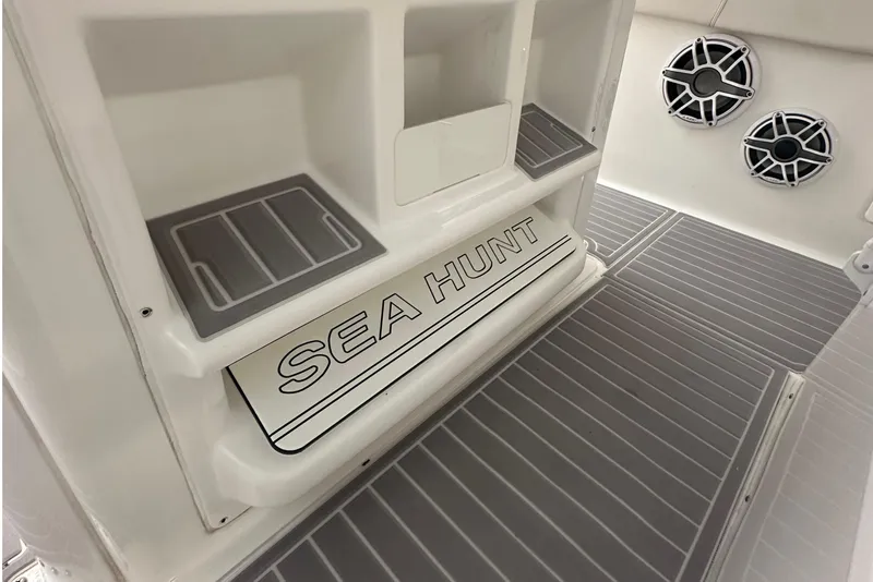 Slide: The Image of 2022 Sea Hunt Gamefish 30 Coffin Box interior with storage and speakers. - 22