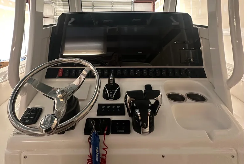 Slide: The Image of 2022 Sea Hunt Gamefish 30 Coffin Box helm with steering wheel and controls. - 23
