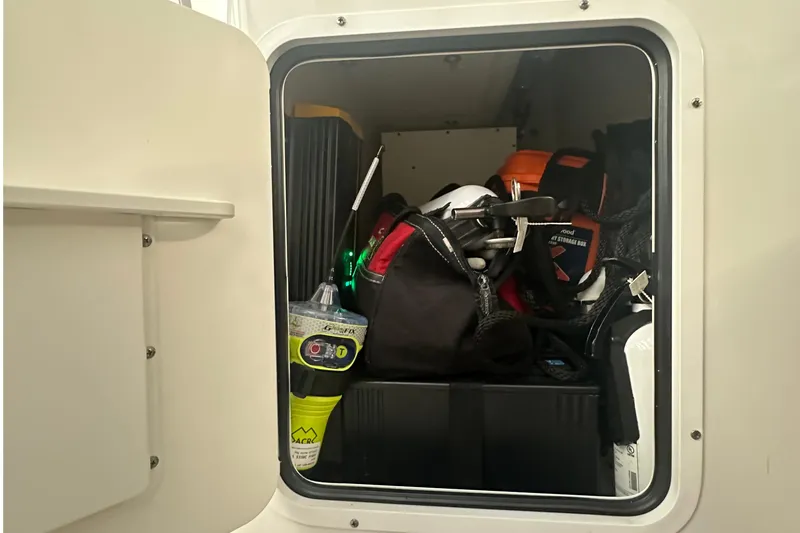 Slide: The Image of Storage compartment of 2022 Sea Hunt Gamefish 30 Coffin Box, filled with boating gear. - 29