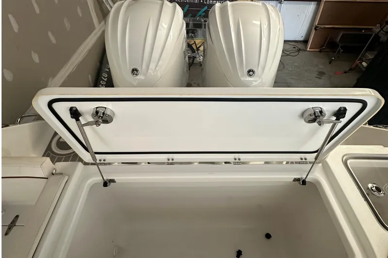 Slide: The Image of 2022 Sea Hunt Gamefish 30 Coffin Box with open storage compartment and dual engines. - 30