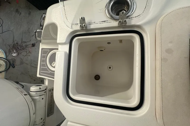 Slide: The Image of 2022 Sea Hunt Gamefish 30 Coffin Box interior view, featuring storage compartment and cup holder. - 31