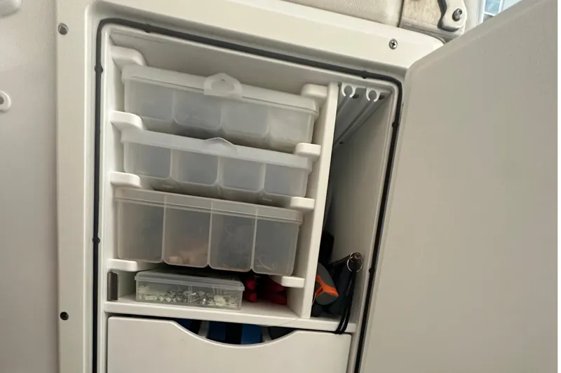 Slide: The Image of Storage compartment with tackle boxes on a 2022 Sea Hunt Gamefish 30 Coffin Box boat. - 33