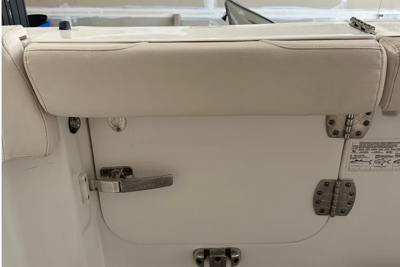 Slide: The Image of 2022 Sea Hunt Gamefish 30 Coffin Box boat interior with cushioned seating and latch. - 43