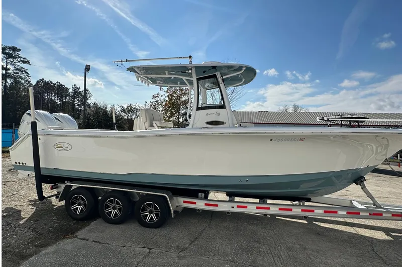 Slide: The Image of 2022 Sea Hunt Gamefish 30 Coffin Box boat on trailer under clear sky. - 5