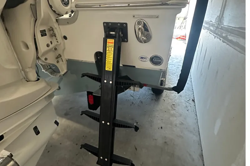 Slide: The Image of 2022 Sea Hunt Gamefish 30 Coffin Box boat with trailer and ladder in garage. - 6