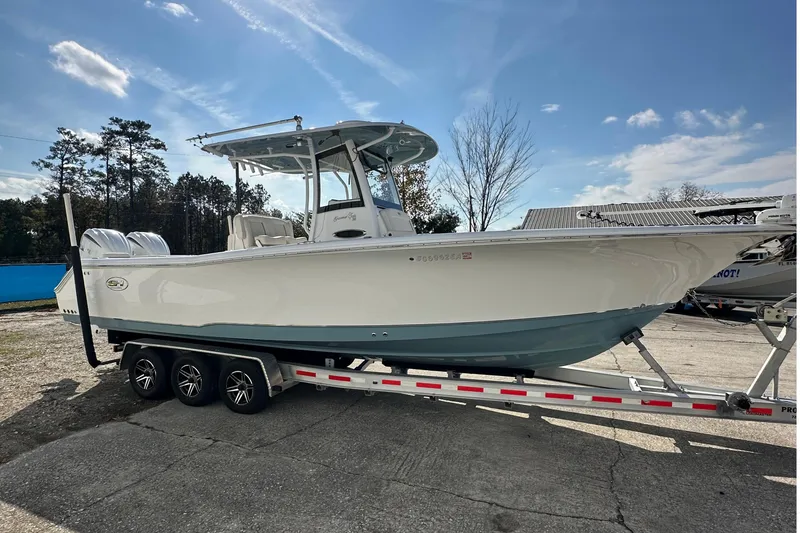 Slide: The Image of 2022 Sea Hunt Gamefish 30 Coffin Box boat on trailer, parked outdoors. - 7