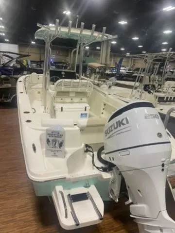 Slide: The Image of 2025 Bulls Bay 230CC boat with Suzuki 250 engine displayed indoors. - 4